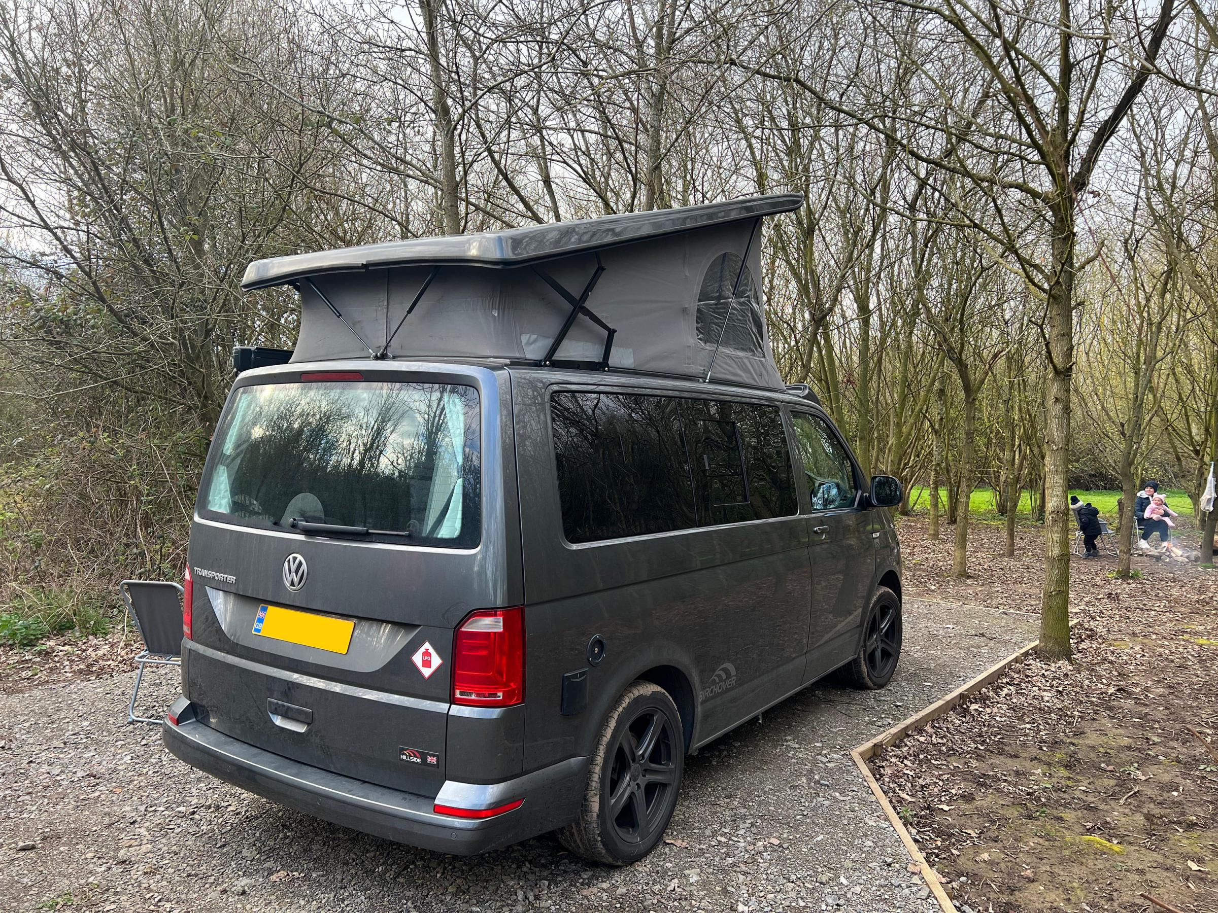 A dedicated campervan pitch within the woodland